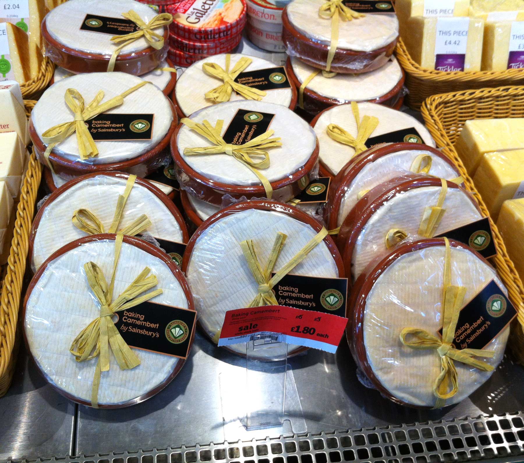 Camembert cheese packaging in clay dishes for baking