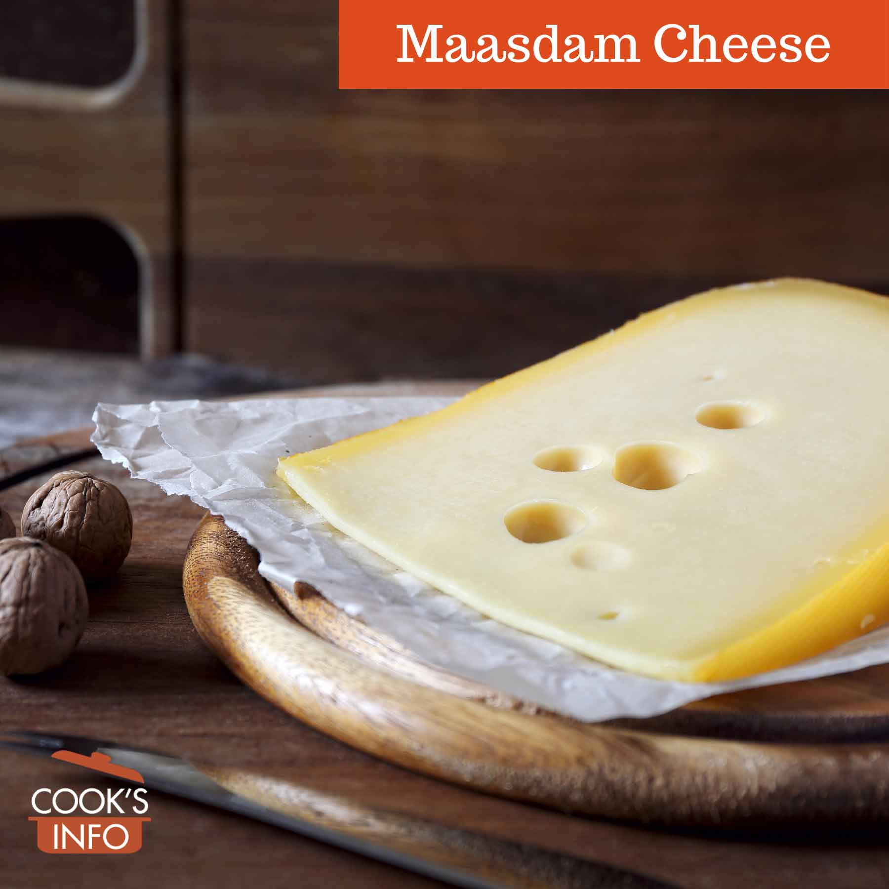 Maasdam Cheese and walnuts on a wood cutting board