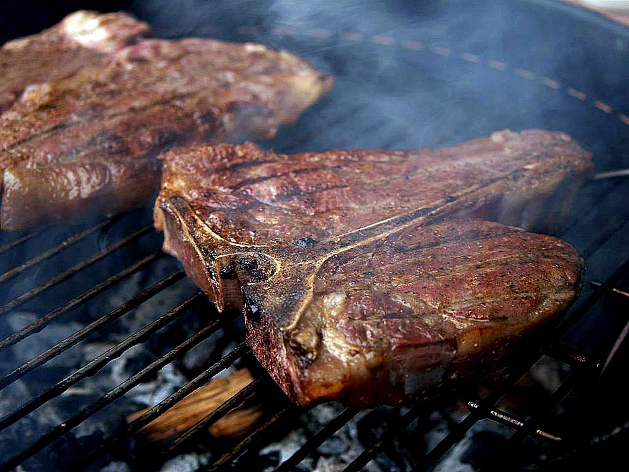 Porterhouse steaks on grill.