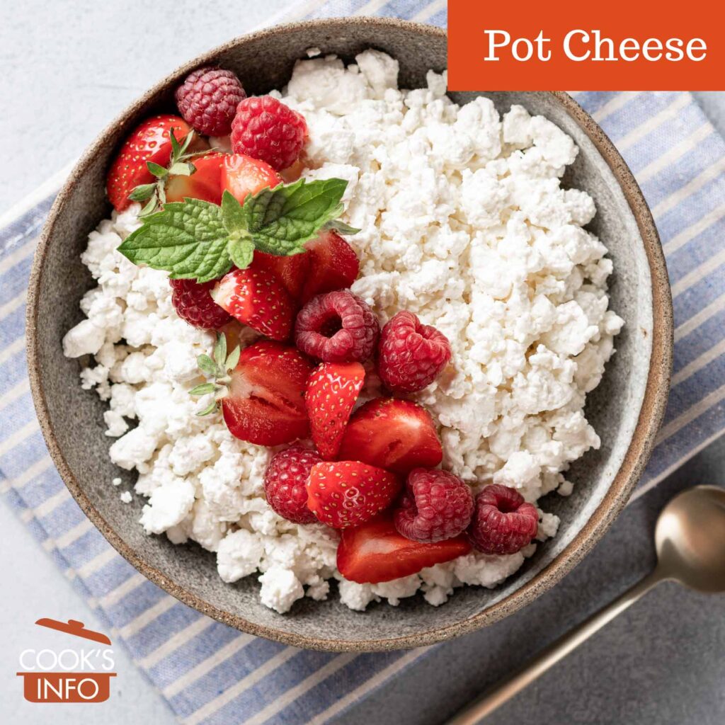 Pot cheese in bowl with strawberries