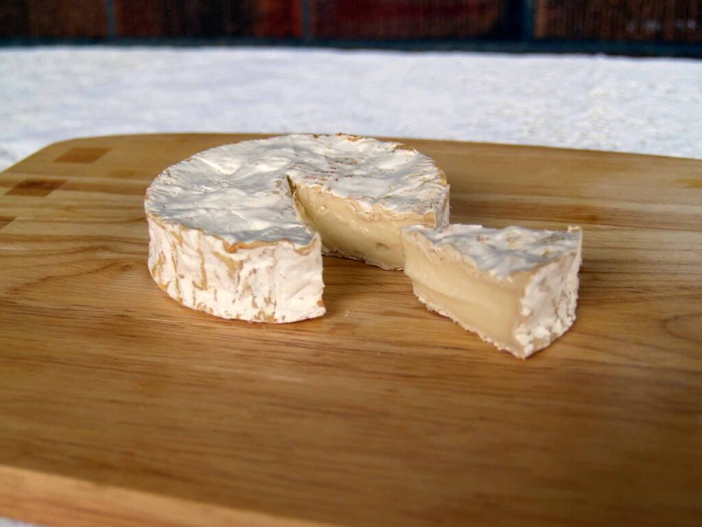 Saint-Loup goat cheese showing wedge cut-out