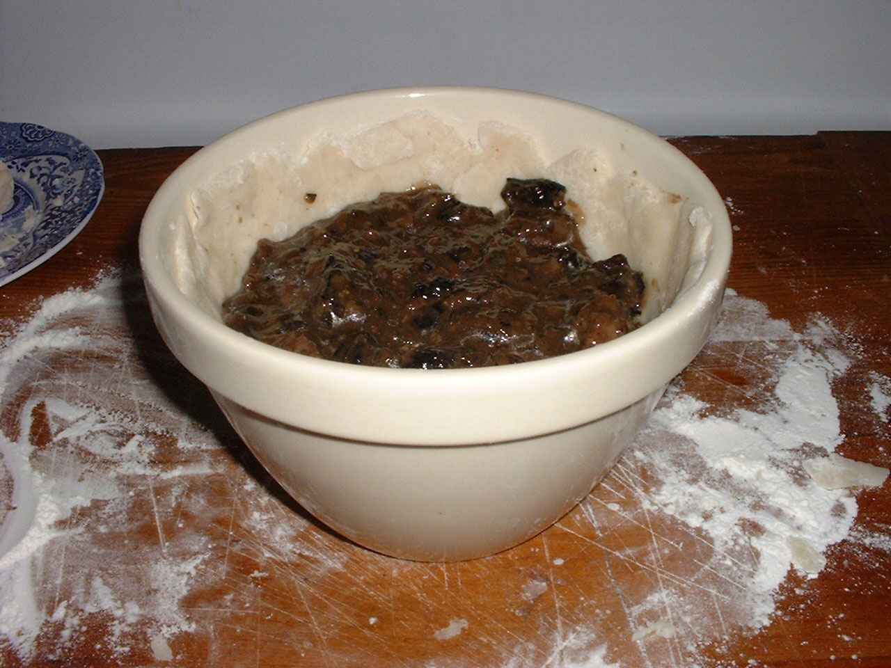 Putting filling into steamed pudding