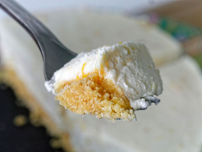 A forkful of cheesecake with crumb crust