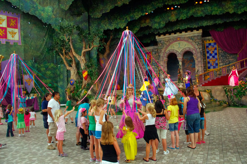 Children learning to dance around maypole