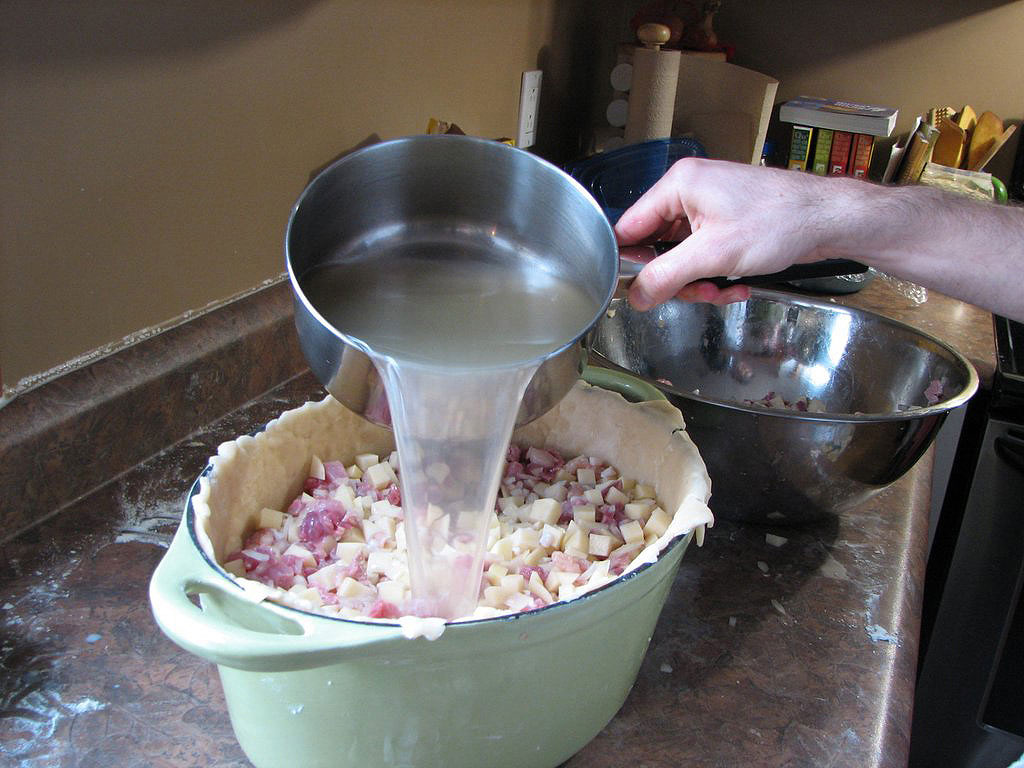 Applying broth to uncooked filling